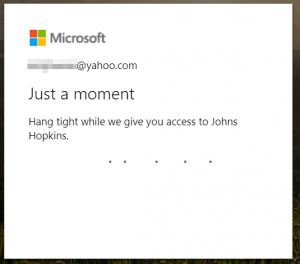 A Microsoft loading page after accepting permissions. It states that it is in the process of granting access to Johns Hopkins.